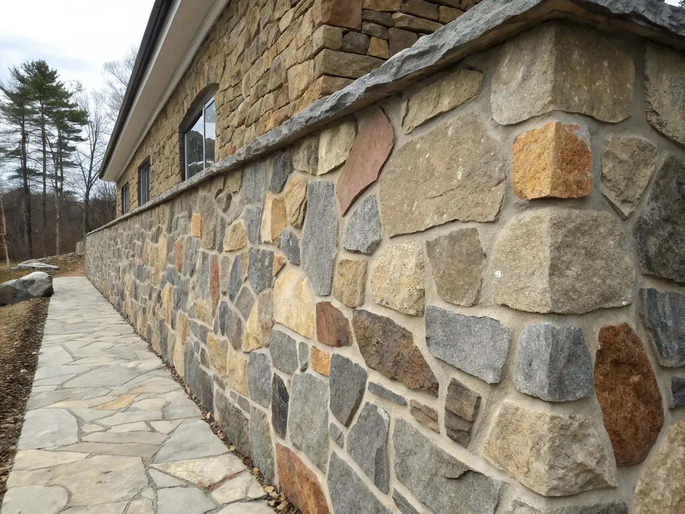 A beautifully restored stone wall of an ancient building in Saint-Priest-la-Feuille, showcasing the meticulous work of the heritage association.